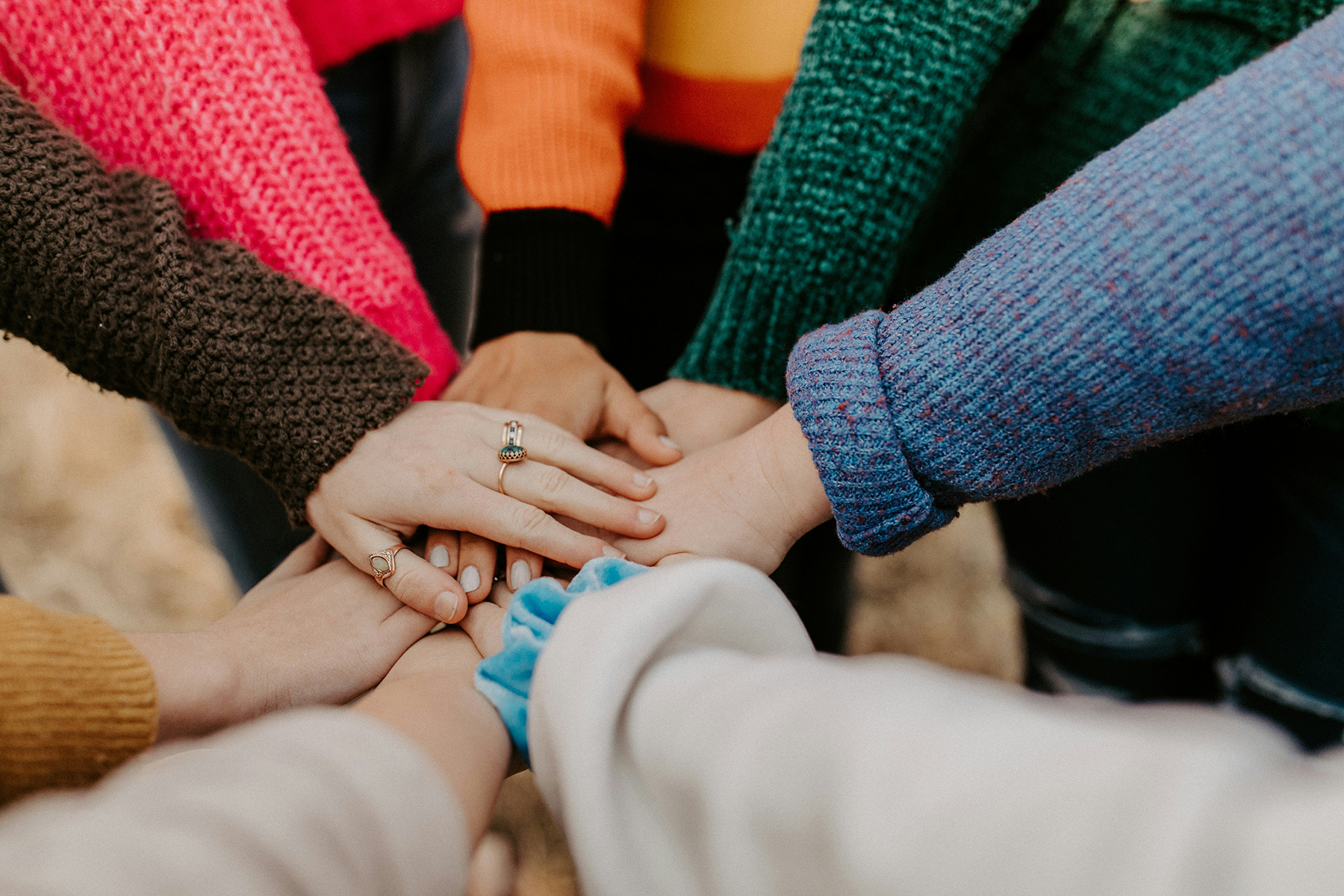 team of people's hands coming together