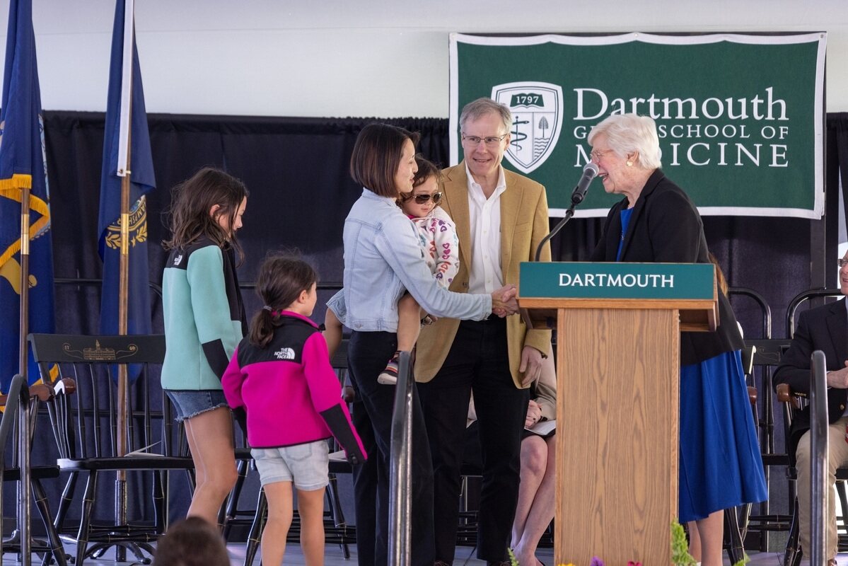 Geisel professor Frances Lim-Liberty, with her children in tow, accepts the C. Everett Koop, MD, Courage Award at an awards ceremony on May 26. Presenting the award were Cora Koop and Steven Bernstein, director of the Koop Institute at Dartmouth.