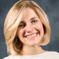 woman with short blond hair smiling