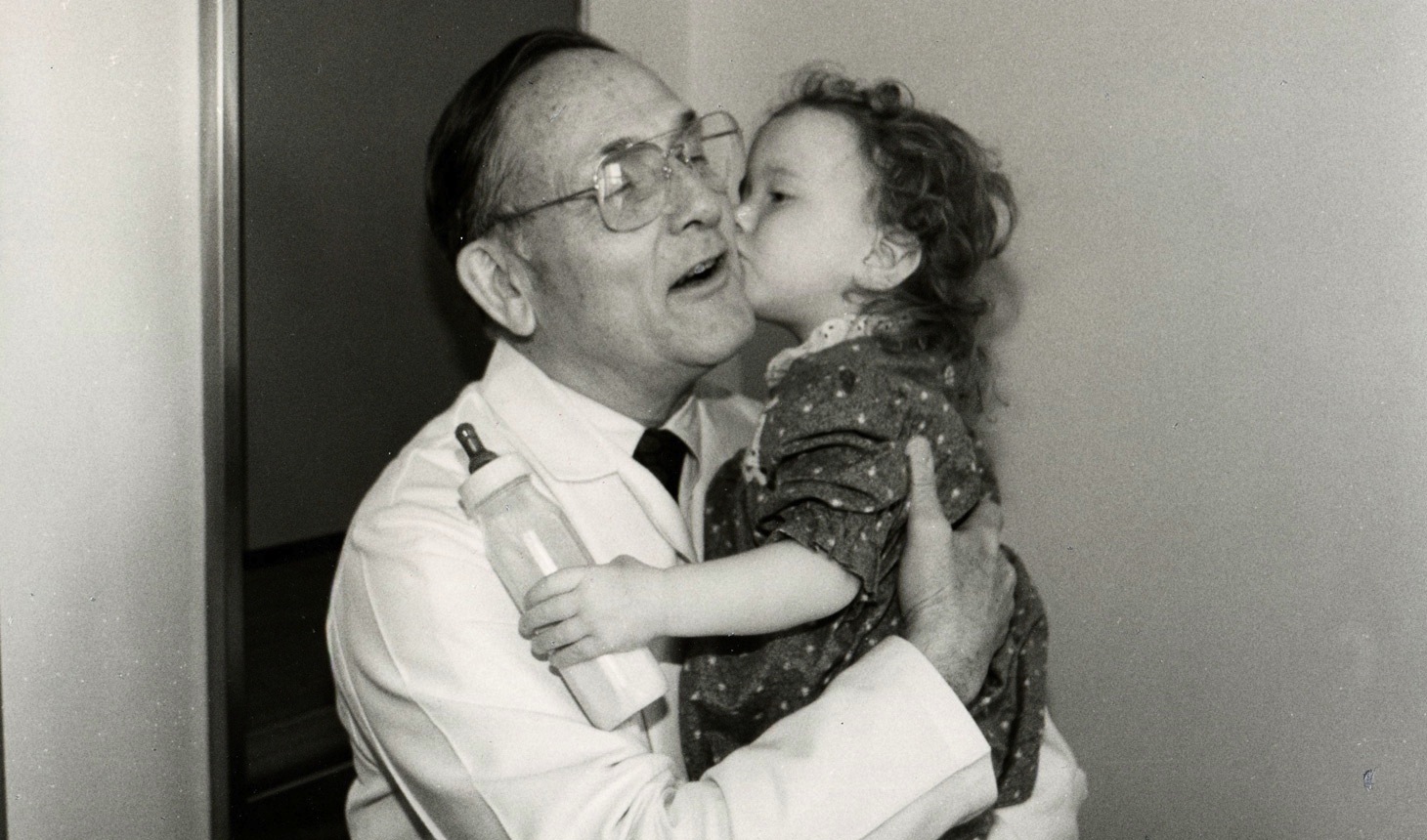 W. Hardy Hendren III, MD, D’47, MED’50 is shown here with a pediatric patient.