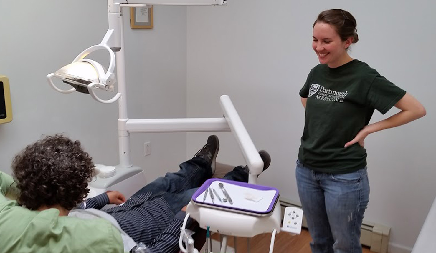 Claire Houge '18, MOLAARS co-leader, smiles as she assists with a dental screening as part of a program for migrant farm workers at Barton Street Dental in Bradford, Vermont.