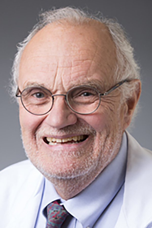 older man smiling openly wearing glasses